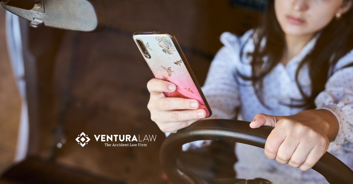 Distracted teen driver texting while driving in Connecticut, highlighting Ventura Law’s commitment to preventing car accidents and promoting teen driver safety.